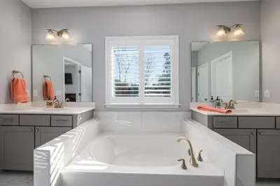 Spacious bathroom with bath in the middle